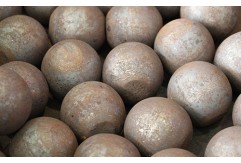 What is the grinding media material in a ball mill?